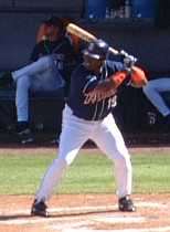Tony Gwynn in a San Diego Padres uniform holding a bat.