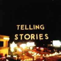 A blurred photograph of a sign reading "TELLING STORIES"