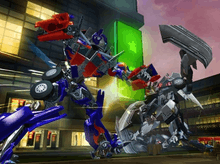 Screenshot of Wii gameplay, showing Optimus Prime attacking an unknown Decepticon. A stylized Shanghai street fills in the background.