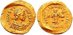 A golden coin showing the bust of Justin I along with its reverse, which depicts victory holding a globus cruciger.