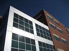 Tuality Healthcare's office building is a five story red brick structure with silver colored metal and glass accents.