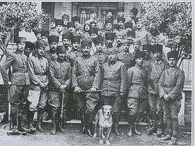 Large group photo, with a dog in front