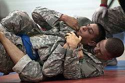 A U.S. Soldier utilizes back mount during a combatives competition.