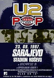 A dark blue rectangular concert poster displayed vertically. At the top is a logo bearing the words "U2 POPMART", with "Tour '97" in small print beneath. Across the middle are 4 high-contrast, monochrome headshots of individual men's faces. Beneath is bold text reading "23. 09. 97.", "Sarajevo", and "Stadion Kosevo". Near the bottom in small print are other various concert details.