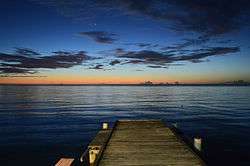 Twilight evening view into the sea (Mona Passage) and the horizing from the shore at Joyuda, Puerto Rico,