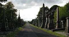 The vista westwards along the main promenade of Undercliffe Cemetery with monuments to either side and the Joseph Smith obelisk in the far distance