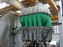 Picture of a plastic tank been removed from its mold after the cooling cycle has been completed.