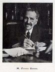 1928 photo of Uzanne at a desk and monocle