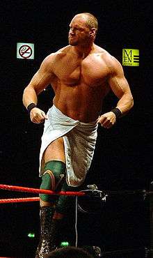 Wrestler Val Venis posing on the second rope before a match.