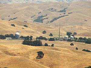Landscape of Vallecitos Nuclear Center set in golden fields with scattered trees
