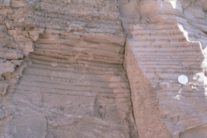 A brown rock or sediment face with horizontal layers, 18 of which are clearly visible. Some of the layers are obviously thicker than others - presumably the result of differences in annual deposition rates due to seasonal variations.