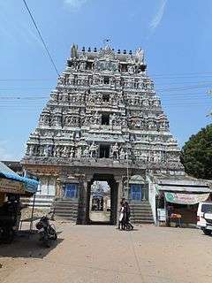 a Hindu temple tower with a street in the foreground