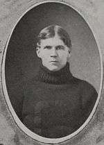 A young Sitton in a dark turtleneck