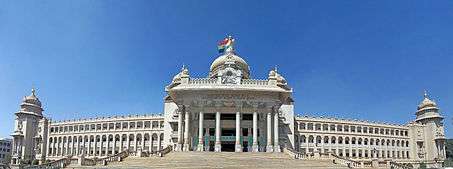 Photo of Bangalore parliament building with 18 archway columns and 10-column entrance under dome with 2 spire towers