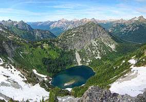 A lake and the surrounding mountains and forest viewed from Maple Pass.
