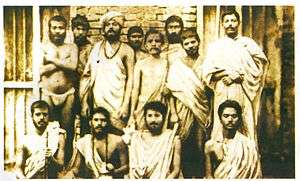 Group photo of Indian young men. Some are sitting, some are standing.