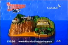 Scale, toy model of a tropical island, with stationary, futuristic air- and spacecraft and "Thunderbirds" and "Carlton" titles