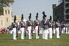 The Regimental Commander gives commands during a parade. text