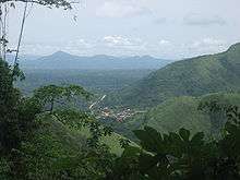 The Volta Region as depicted is lush green, covered in mountains, forests, farmland, and a small town in a valley in the center