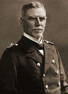 A older man in a double-breasted naval uniform