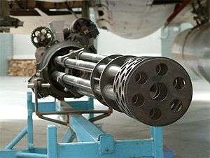 Seven-barrel rotary gun resting on metal rig