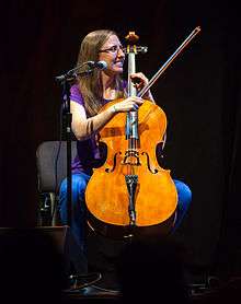Photograph of Aubrey playing a cello.