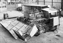 A tank with its 'Sunshield' camouflage half open in workshops near Cairo