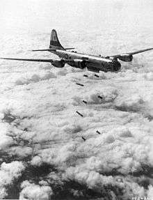 A large aircraft dropping bombs mid-flight