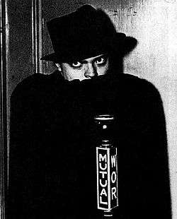 Promotional photograph of Orson Welles dressed as The Shadow, dated 1937 or 1938.