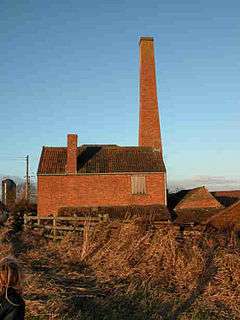 Red brick building with tall chimney.