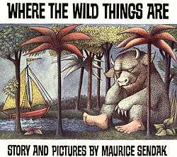 The book cover is an illustration of a sail boat coming into a forested shore. On the shore, sleeping against a tree, is a giant furry monster with bare human feet and the head of a bull. Above the illustration, written in uneven block capital letters against a white background, is the title of the book "Where the Wild Things Are" and below the illustration, "Story and pictures by Maurice Sendak".