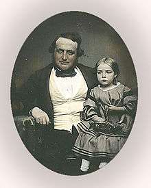 photo of a Victorian man with a girl on his lap