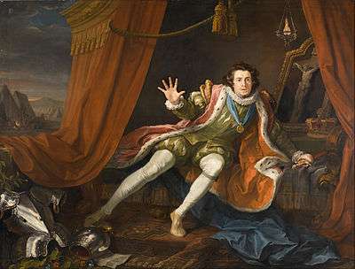 Oil painting of the actor Garrick dressed as a Richard III, sitting on a curtained bed with an attitude of despair. At his feet is a set of armor and behind him is a crucifix.