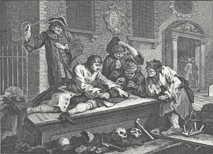 A group of people gambling on a flat tombstone. Scattered human remains are strewn on the ground around them.