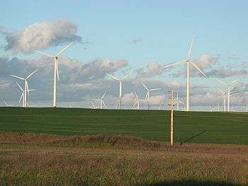 Some of the 1.5 MW Phase I turbines stand 80 metres (260 ft) tall. The surrounding land is used for sheep grazing and growing hay.