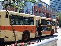 an orange Winnipeg Transit bus in service.
