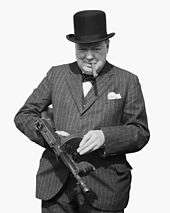 Churchill, wearing a hat and smoking a cigar, holds a submachine gun