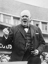 Churchill in mid-speech, his tight hand held in rhetorical pose