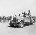 Winston Churchill giving his famous V-for-Victory sign while being driven past a line of troops in Tel-el-Kebir, 9 August 1942. E15387.jpg