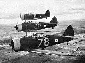 Three single-engined military monoplanes in flight