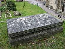 Photograph of a coffin-shaped granite tomb.