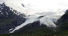 A large glacier sloping down a mountain