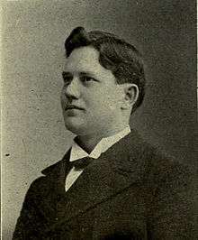 Portrait photo of Wylie Glidden Woodruff in 1898 in a suit looking to the left