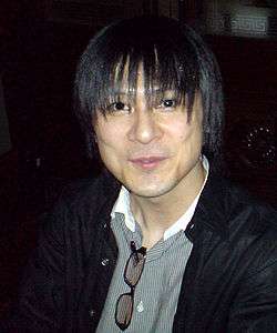 A photograph of a thin, dark-haired Japanese man.