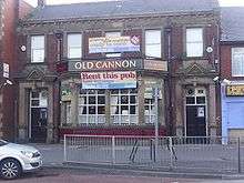 A large, two-storey, red brick building bears the name "Old Cannon" above a large bay window. A banners across the bay window carries the text "Rent this pub: low ingoings", and a banner above the same windows says "property good condition ready to open" and "Call now".