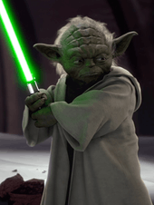 Yoda holding a lightsaber.