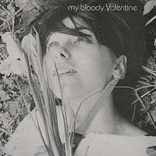 A black and white image of a woman laying on grass. To the left side of her face, she holds a bunch of flowers and to the right side of her face, she holds a knife. The text on the top right corner of the image reads "My Bloody Valentine".