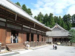 A wooden building with slightly raised floor and wooden sliding doors.