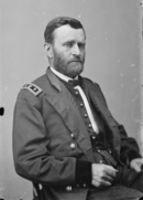 Bearded man in an army uniform, sitting